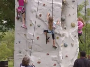 Children climb on a wall