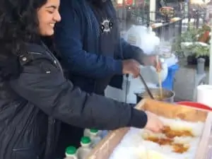 People making maple syrup snow candy