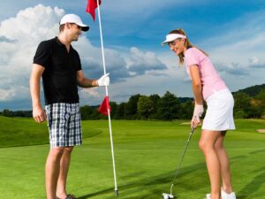 Young sportive couple playing golf course