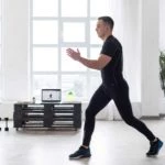 Man doing fitness exercise in clean white room